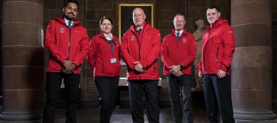 Five members of the Security team wearing red jackets