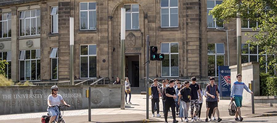 People walking and a cyclist coming towards camera