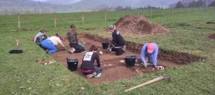 Students taking part in a mock archaeological dig