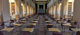 Exam desks in Playfair Library. The desk at the front right has been refurbished