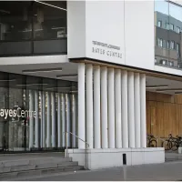 Close up of Bayes Centre Building with thin white pillars 
