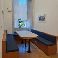 A table with benches in a room