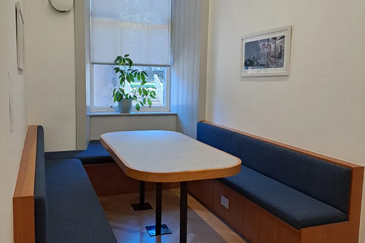 A table with benches in a room
