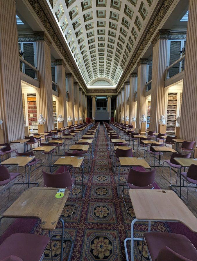 Exam desks in Playfair Library. The desk at the front right has been refurbished